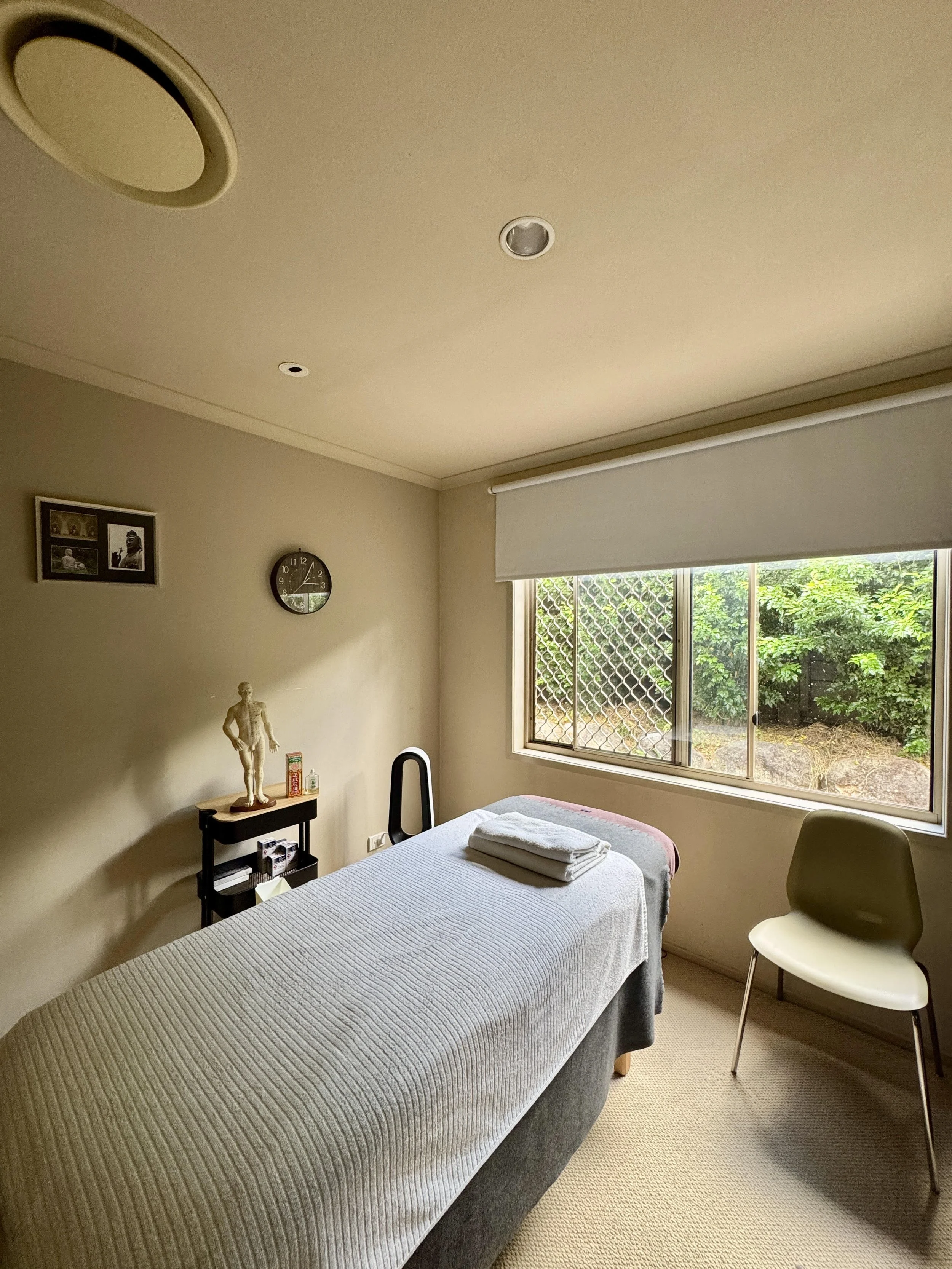 Acupuncture treatment room at Bridgeman Downs clinic in Brisbane with massage table and natural light.