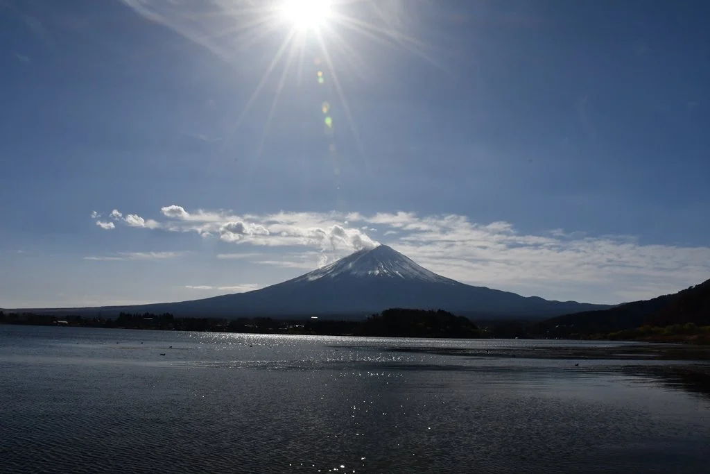 Sunstar effect above the snow-capped peak of Mount Fuji, Japan