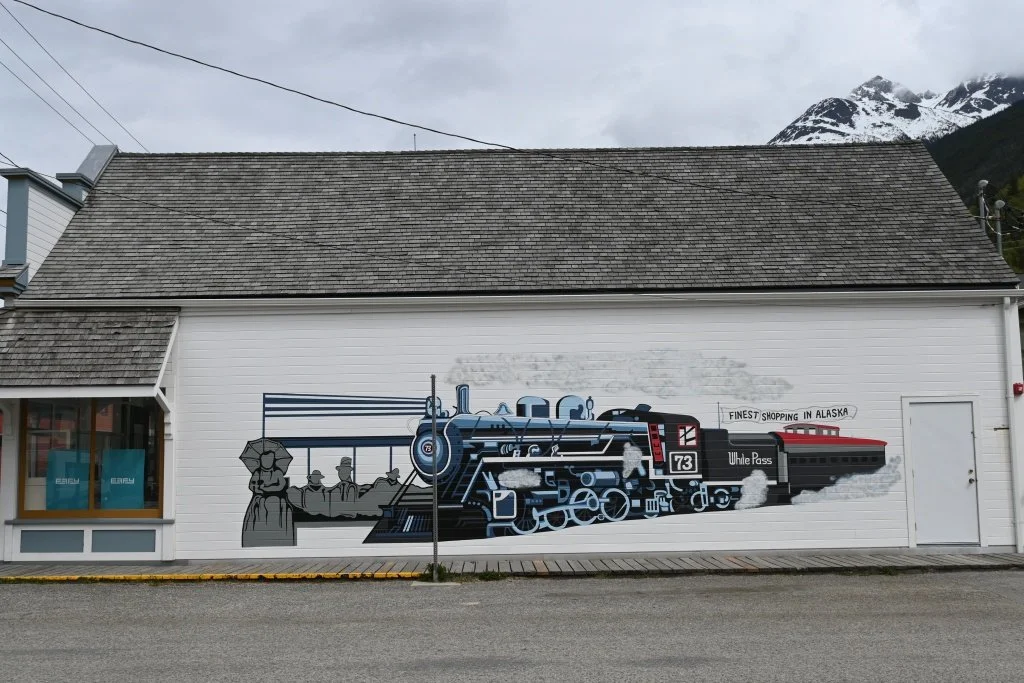 White Pass train mural painted on building wall in downtown Skagway Alaska