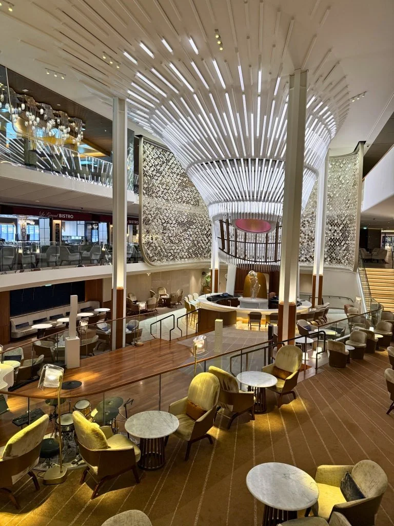 Celebrity Edge Grand Plaza interior surrounded by restaurants cafe and retail shops