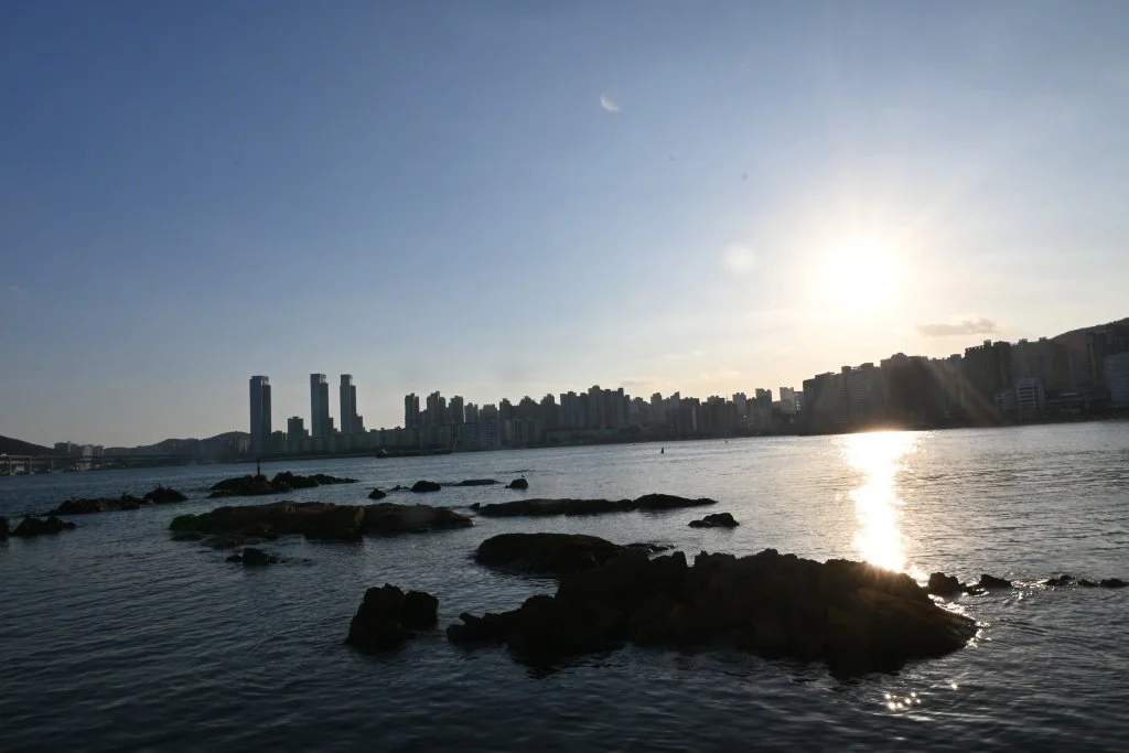 Golden hour sunstar over the city skyline, Songdo Skywalk, Busan, South Korea
