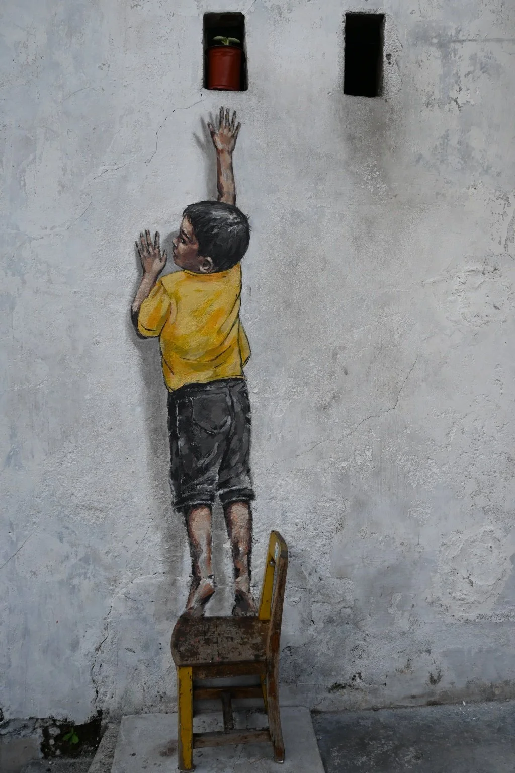 Boy on Chair street art mural at Lebuh Cannon George Town Penang