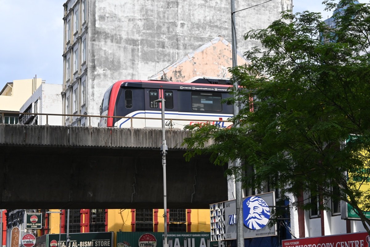 Rapid KL LRT train passing above shophouse-lined streets in Downtown Kuala Lumpur