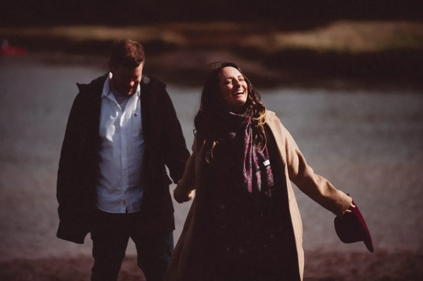 Amie Duke-Woolley, founder of Wild Mind Studios, laughing outdoors by the water in Wivenhoe Essex
