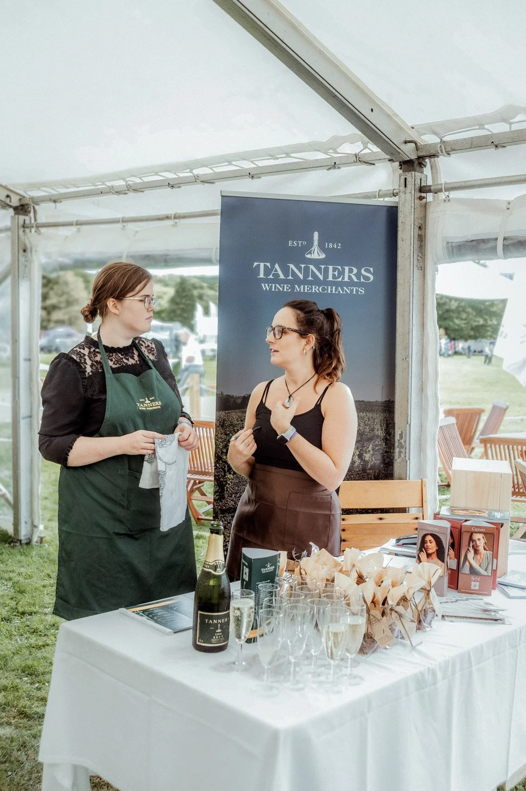 Staff serving prosecco at the Tanners Wine Merchants stand, Welsh Game Fair — event photography by Wild Mind Studios