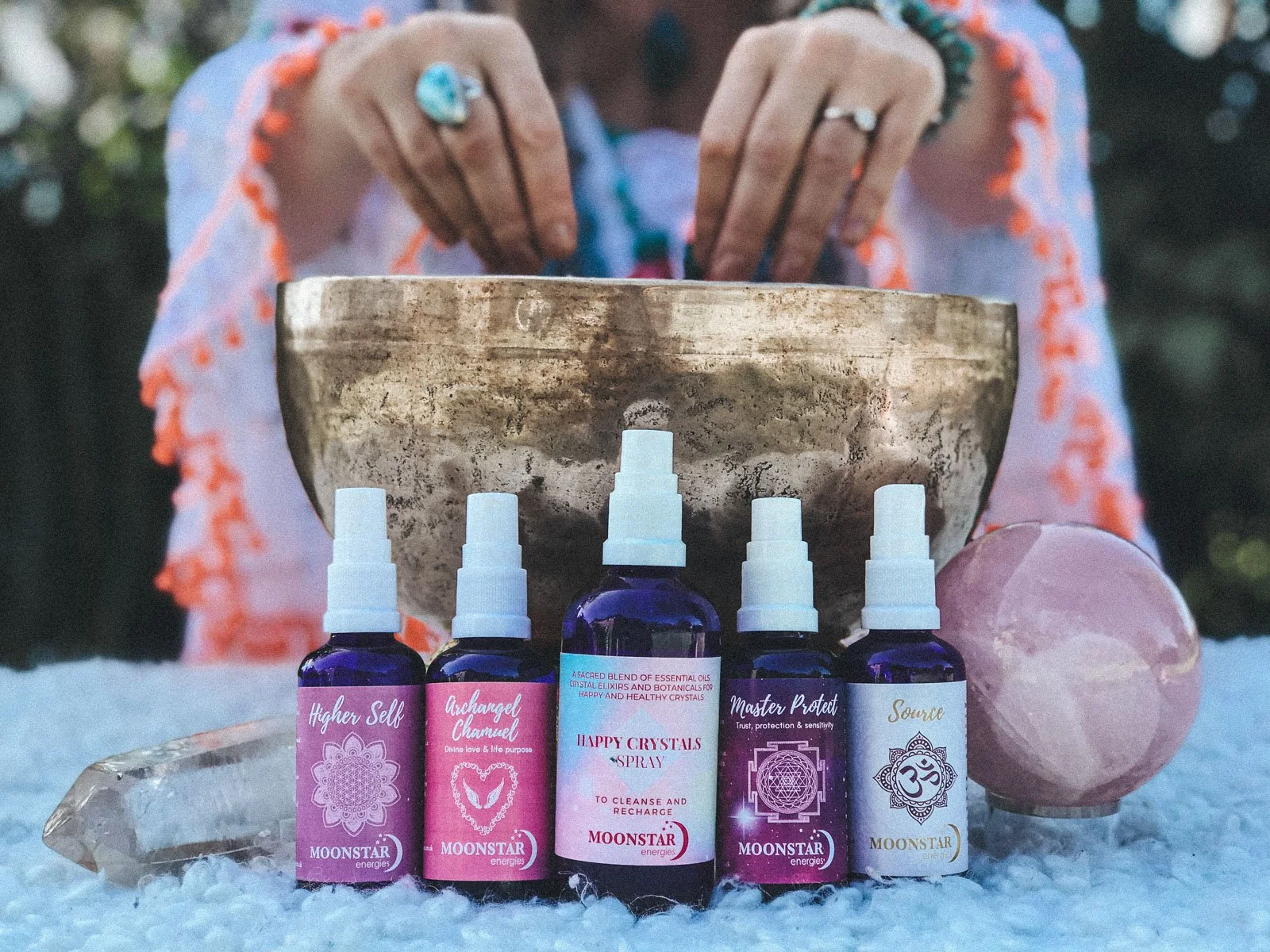 Moonstar Energies crystal spray bottles styled with a singing bowl and crystals — product photography by Wild Mind Studios