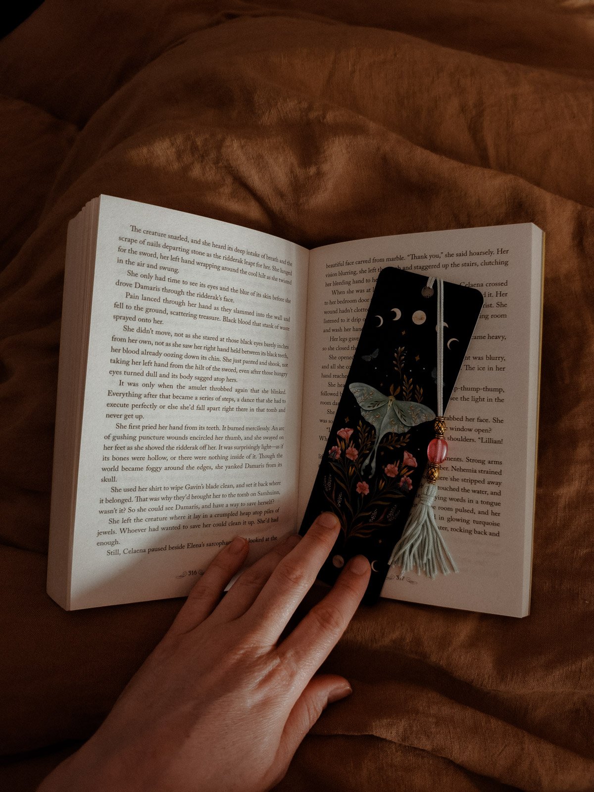 Amie reading with a moth-illustrated bookmark, journal welcome page