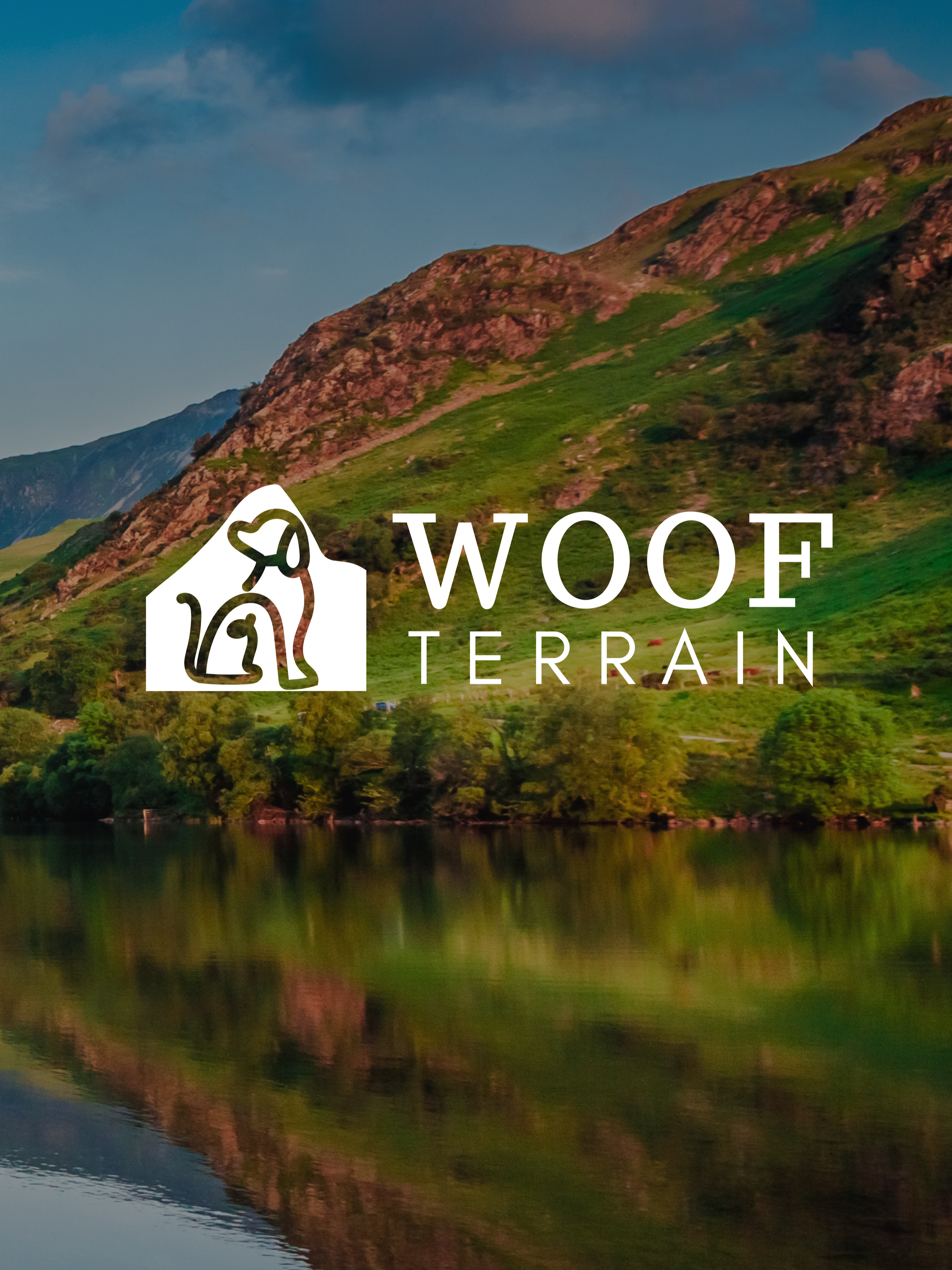 Woof Terrain branding by Wild Mind Studios of a Scenic view of green hills and mountains reflected in a calm lake during sunset in The Lake District, Cumbria featuring Woof Terrain logo in white overlayed with a dog icon.