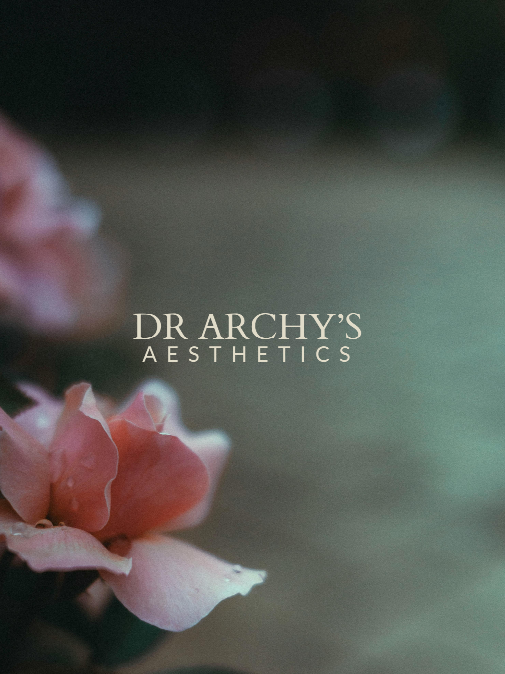 Brand Identity design by Wild Mind Studios, Close-up of a pink flower with the text 'Dr Archy's Aesthetics' overlayed on a blurred green and black background.