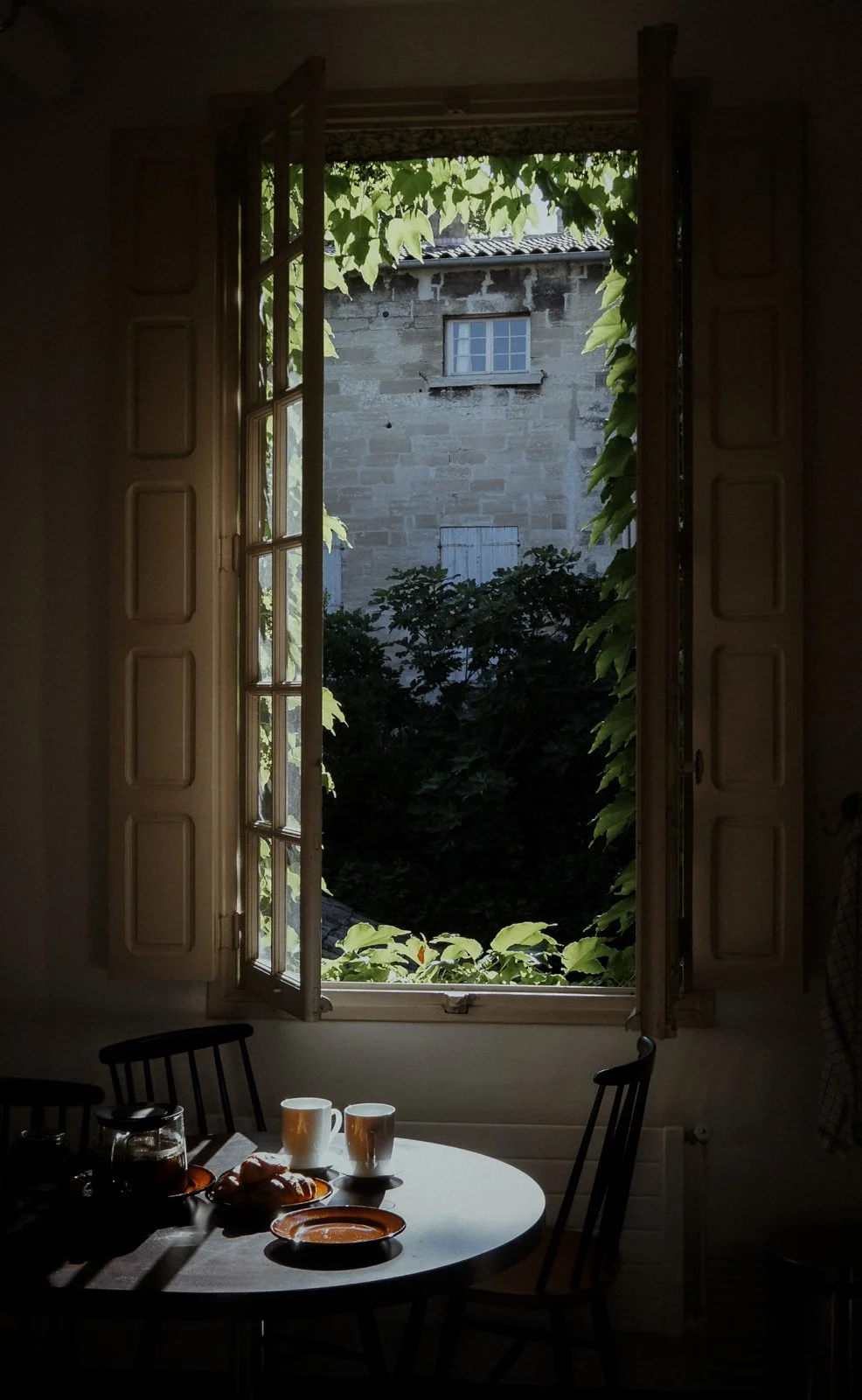Open window overlooking Avignon with a breakfast table below, journal welcome page