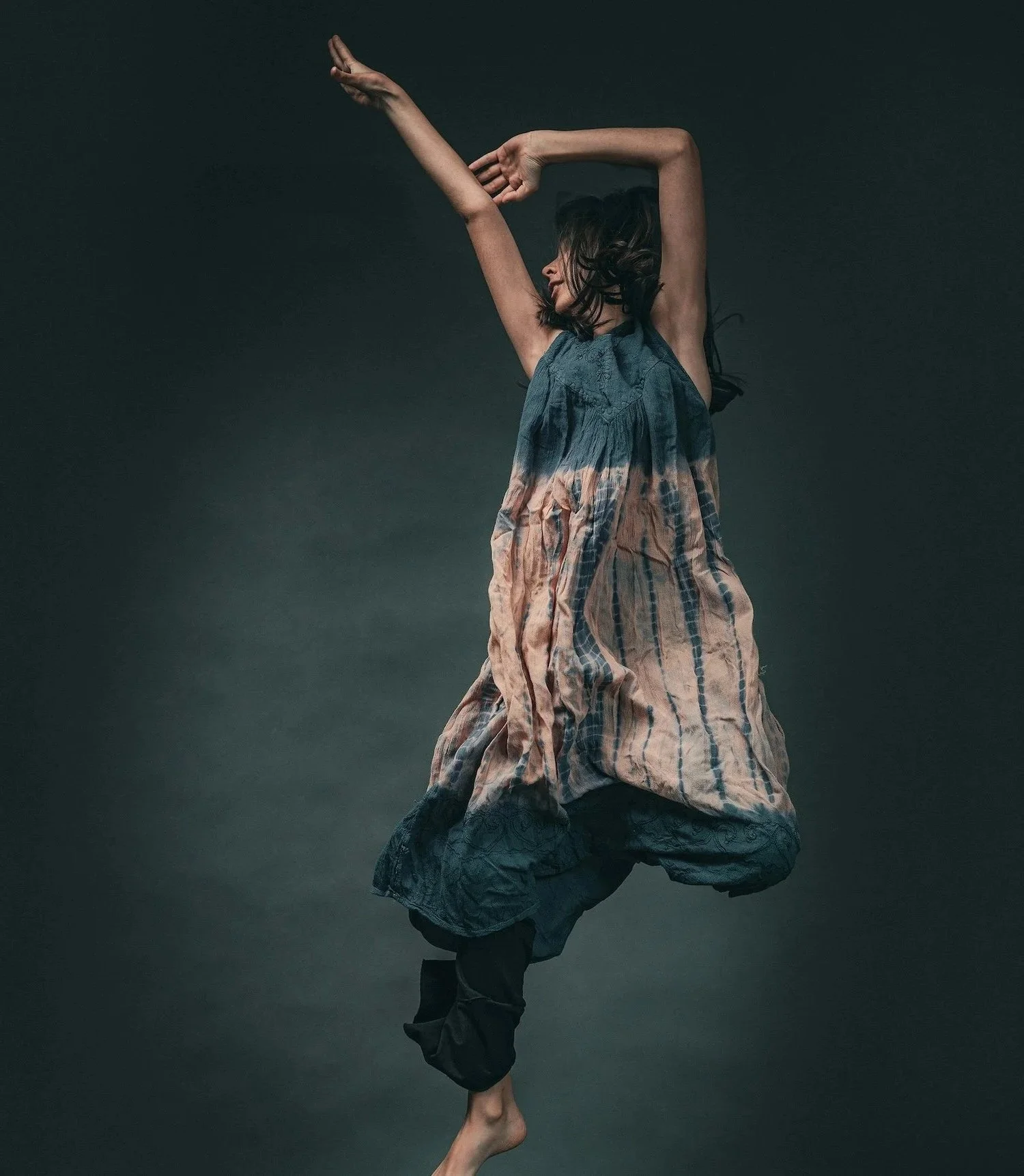 An alexander technique teacher adjusting a woman's lower back, with a skeleton model in the foreground.