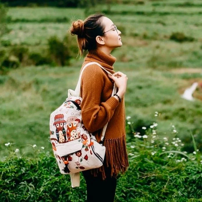 Young woman breathing, relaxing in meadow