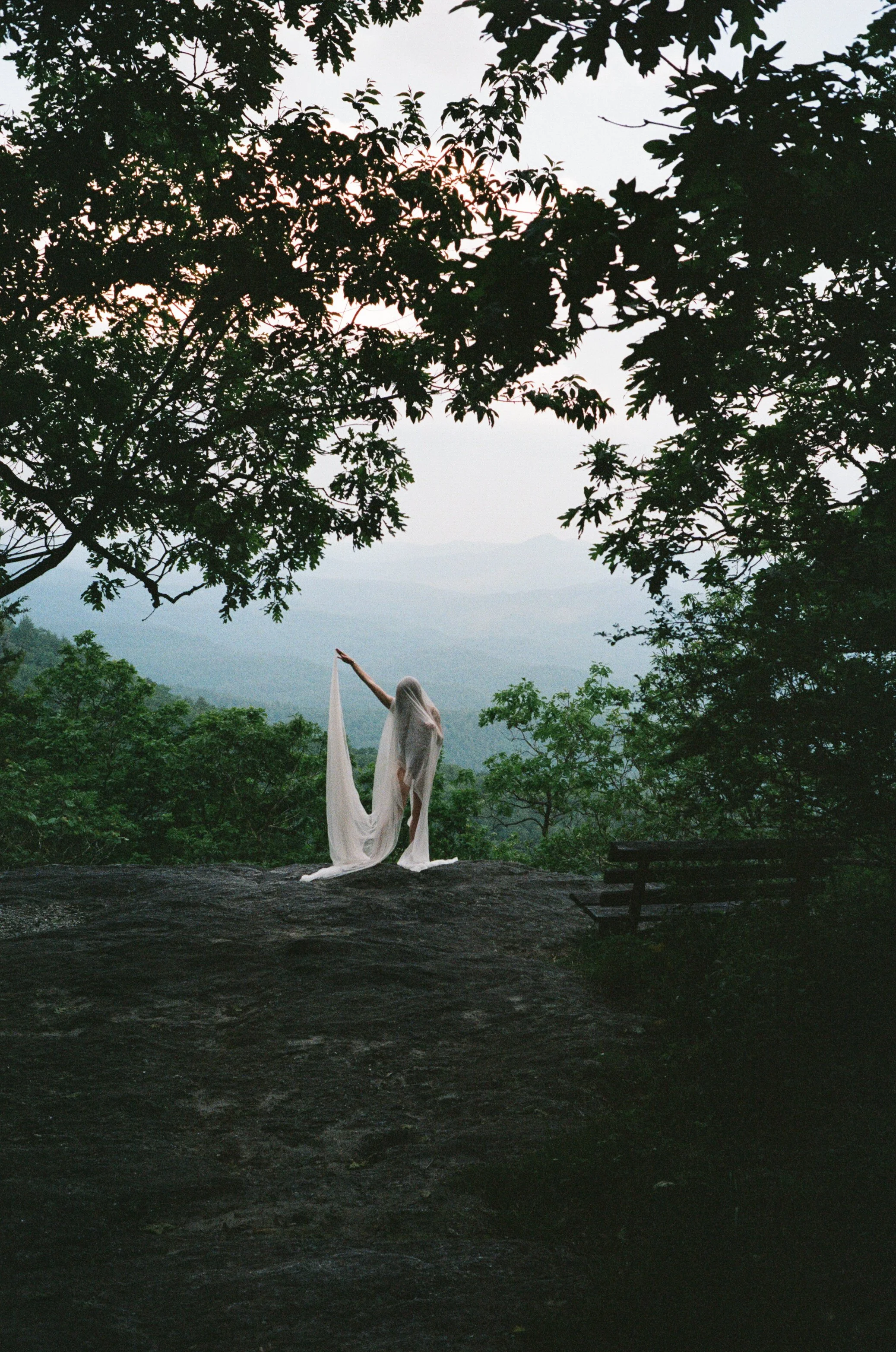 Analog photograph of a figure in a flowing pale dress overlooking the Appalachian mountains.