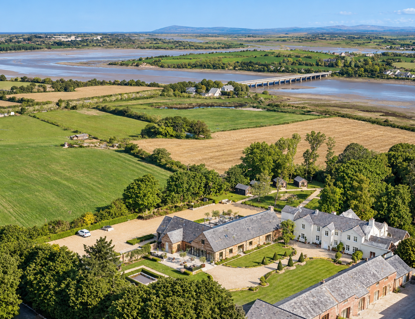The River Barn, Poulton-le-Fylde, Lancashire — Aerial View — Aerial photograph showing the wedding venue and its rural setting, surrounded by open countryside and overlooking the River Wyre estuary.