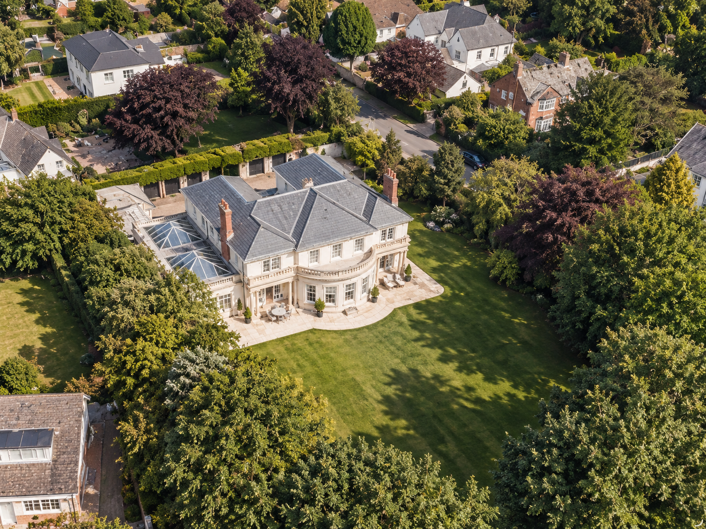 Applegarth, Islay Road, Lytham, Lancashire — aerial view of the rear elevation of a luxury detached residence featuring classical architecture, a glazed garden room, extensive lawns and mature landscaped grounds.