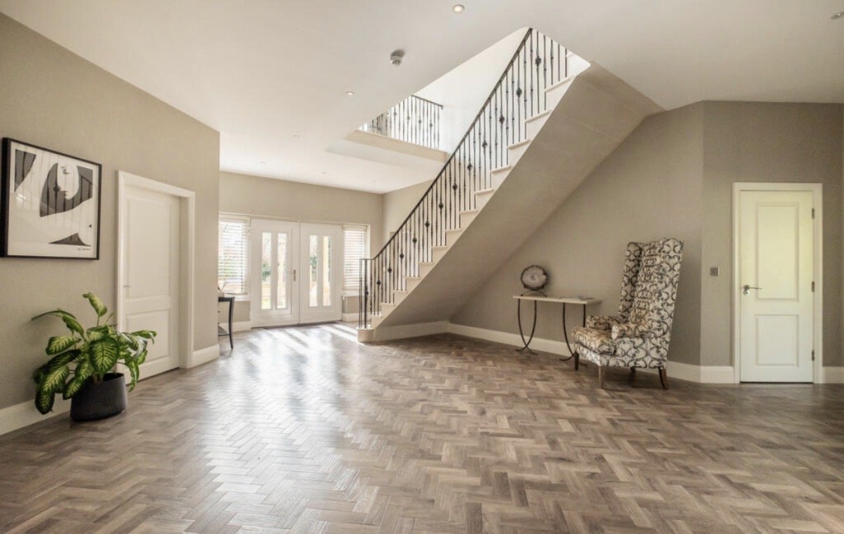 Regent Avenue, Lytham St Annes — Entrance Hall Interior Design — alternative view of the spacious entrance hall, highlighting the sweeping staircase, decorative balustrade, contemporary flooring and generous proportions. The open layout and natural l