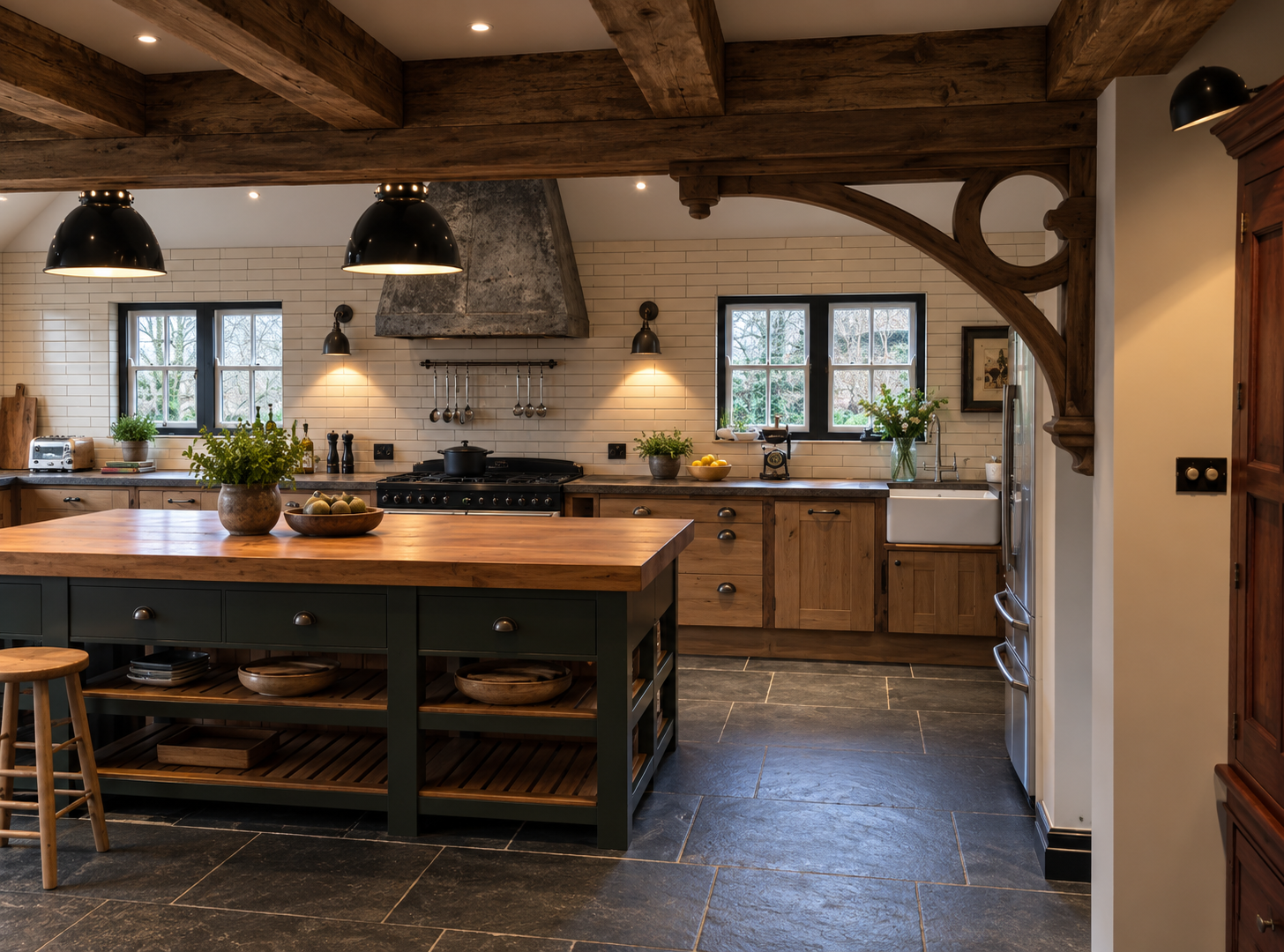 Handmade farmhouse kitchen incorporating reclaimed ironwork from original farm buildings, exposed timber beams, bespoke cabinetry and natural stone flooring.