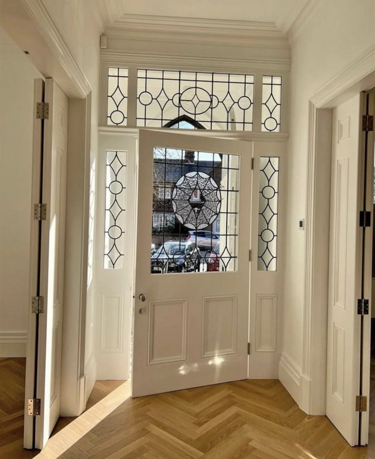 Refurbished entrance hallway with decorative glazing and traditional detailing.