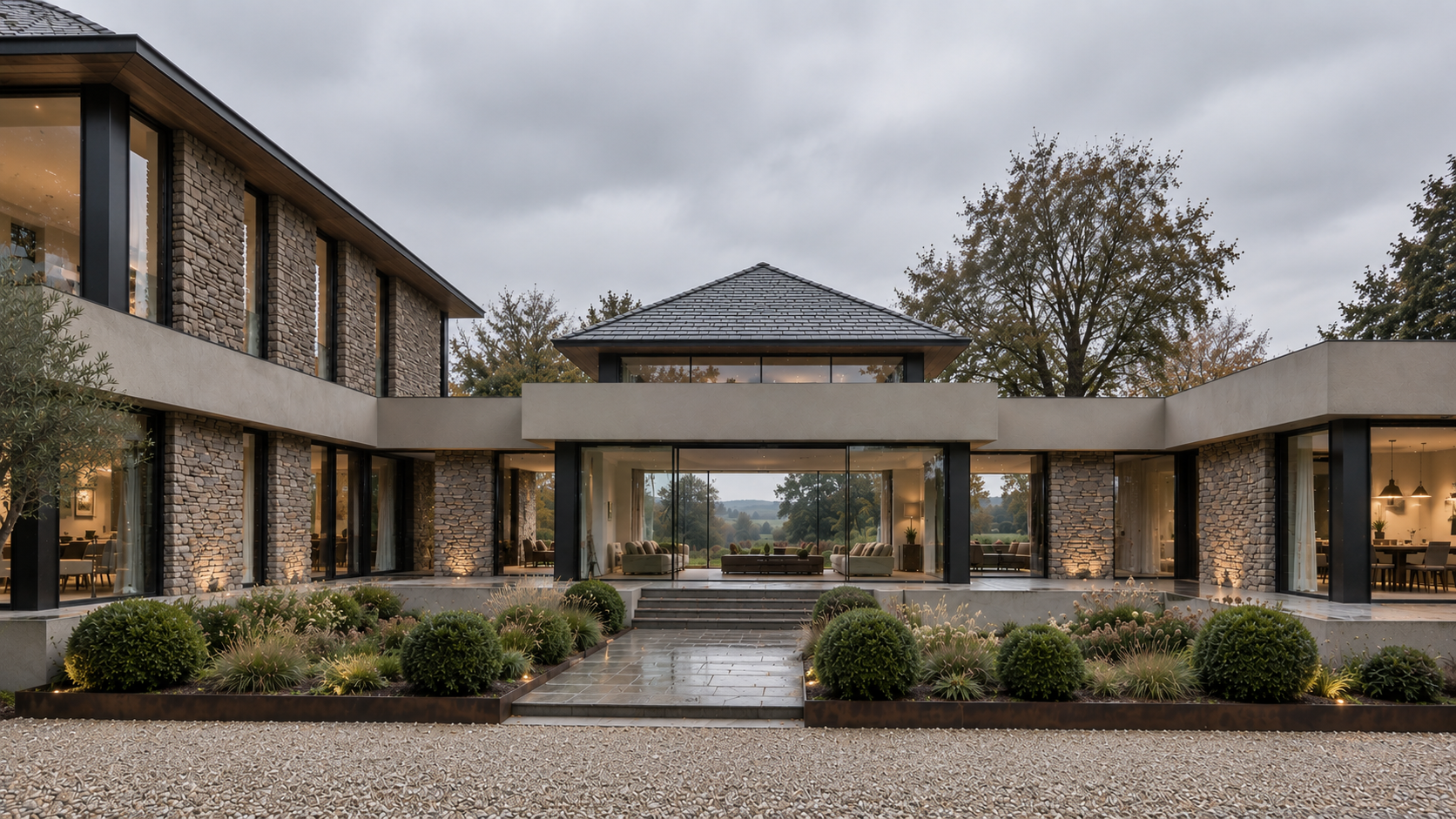 Front entrance courtyard of Bankfield, Poolfoot Lane, Singleton, Lancashire, a bespoke new-build country house designed by Chartered Architect Joel Firth. The symmetrical courtyard composition, natural stone and extensive glazing create a framed view