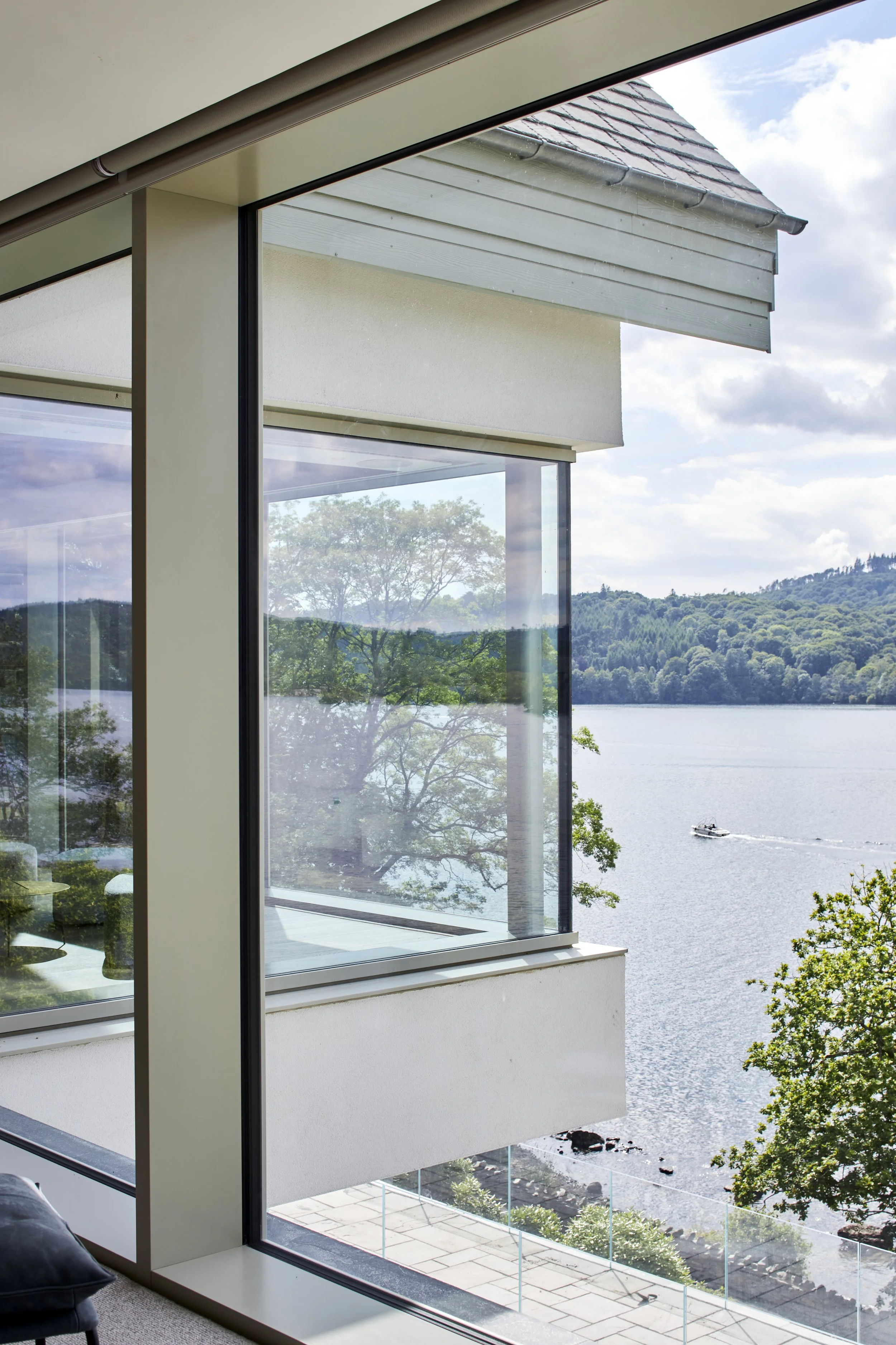 Otter Bank, Lake Windermere — view from the study, with floor-to-ceiling glazing framing uninterrupted views across the lake and surrounding Lake District landscape.