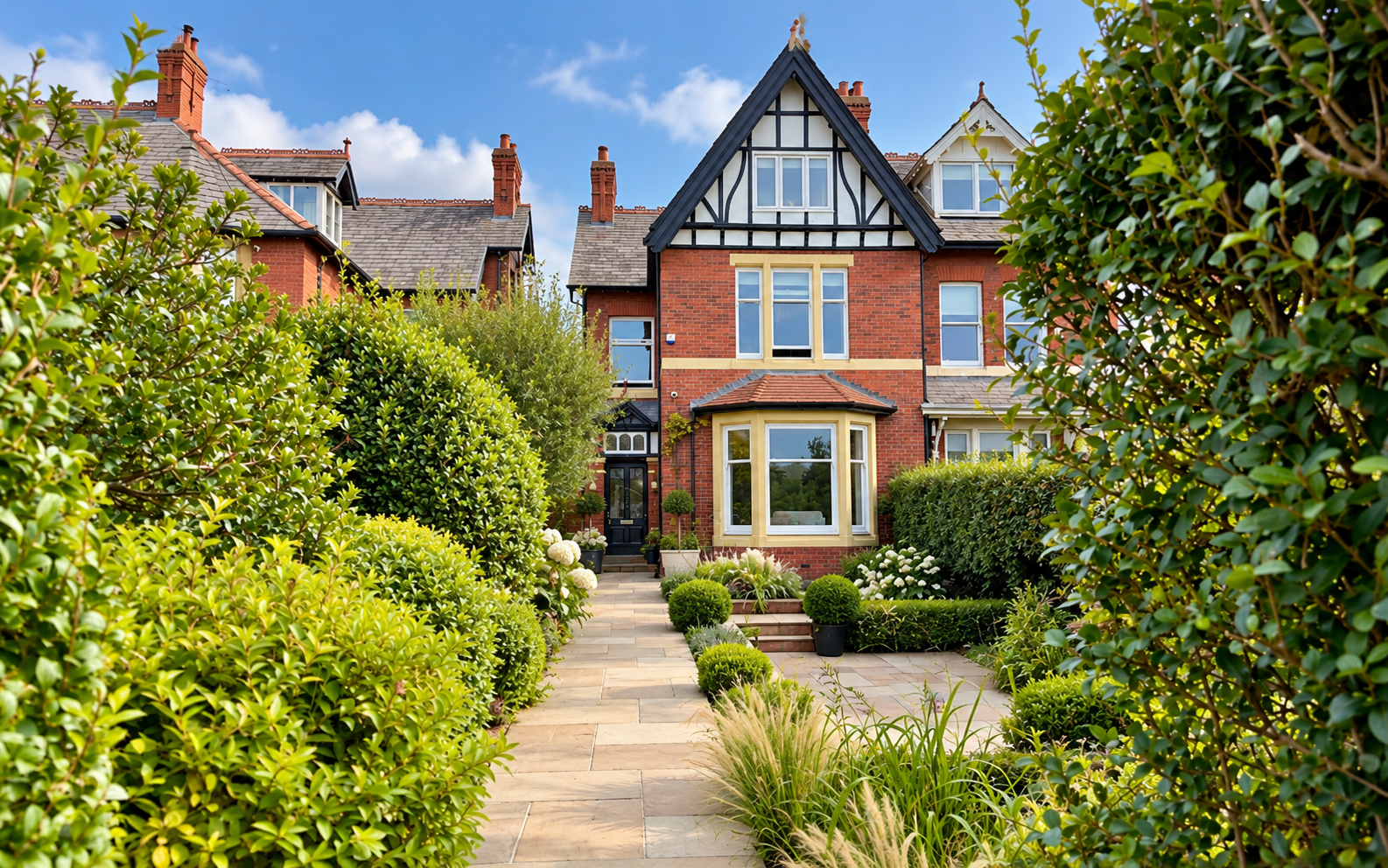 Front Elevation — Renovated Victorian residence featuring distinctive Tudor-style gables, traditional red brickwork and beautifully landscaped entrance gardens.