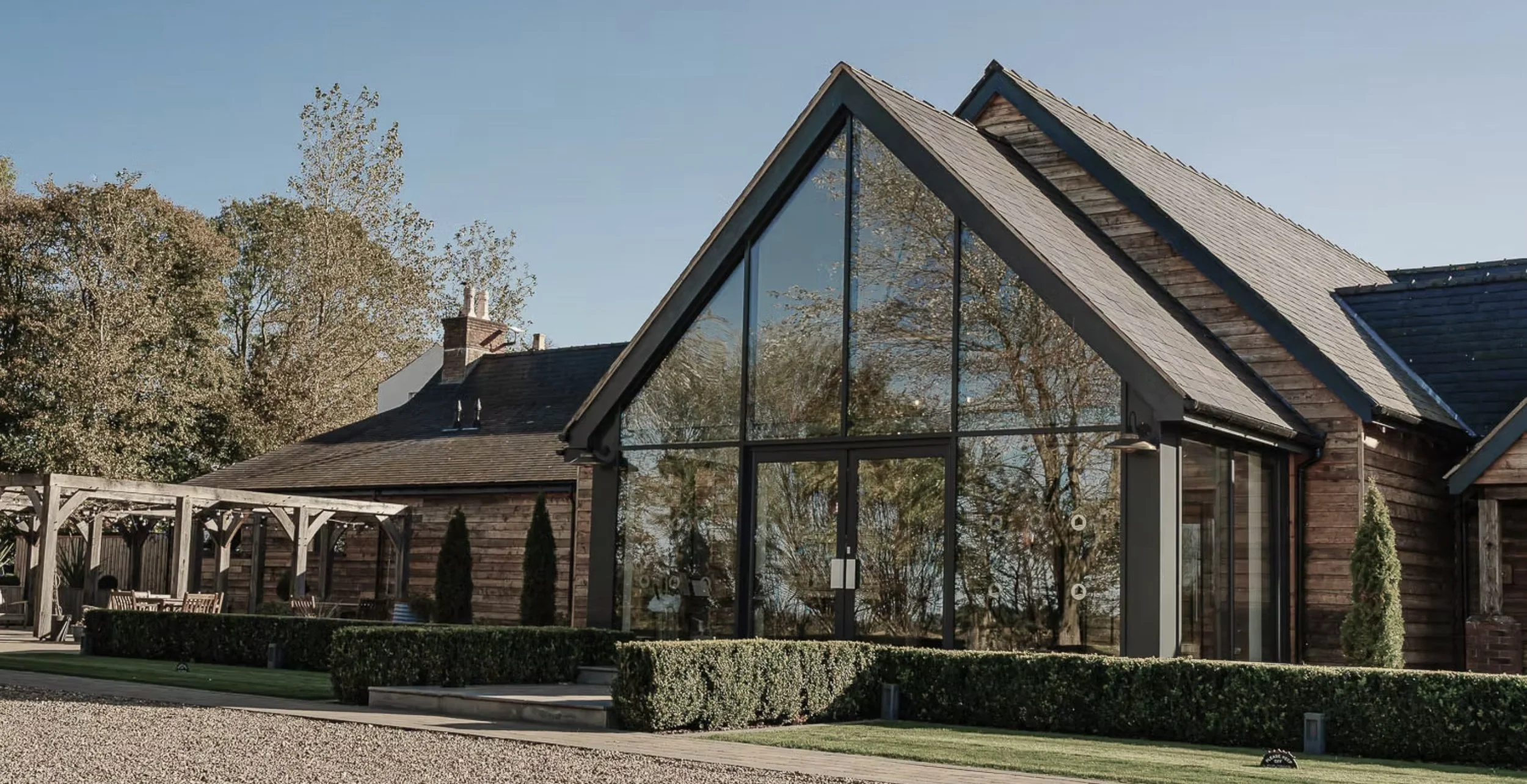 The River Barn, Poulton-le-Fylde, Lancashire — New Entrance — Completed glazed entrance extension featuring a dramatic full-height gable, contemporary detailing and landscaped approach, creating an impressive arrival experience for the wedding venue.