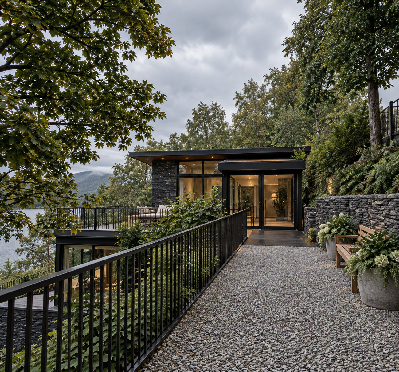 Lakeside Corporate Retreat, Windermere — Main Entrance and Arrival Walkway — architectural visualisation of the planning-approved main entrance, approached via a landscaped walkway overlooking Lake Windermere. Natural stone, expansive glazing and a s