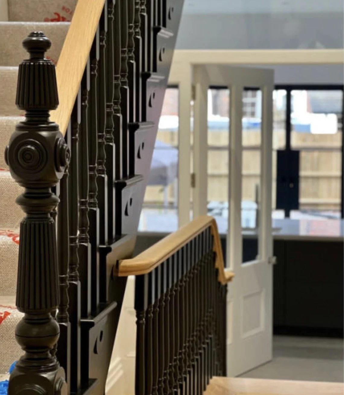 New timber staircase with ornate balustrade and contemporary finishes.