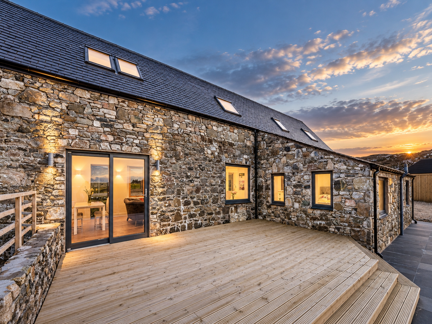 Natural stone elevations and slate roofing reflecting the island's traditional architecture.
