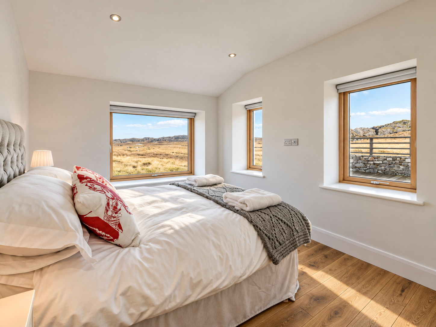 Light-filled bedroom with contemporary furnishings and panoramic countryside views.