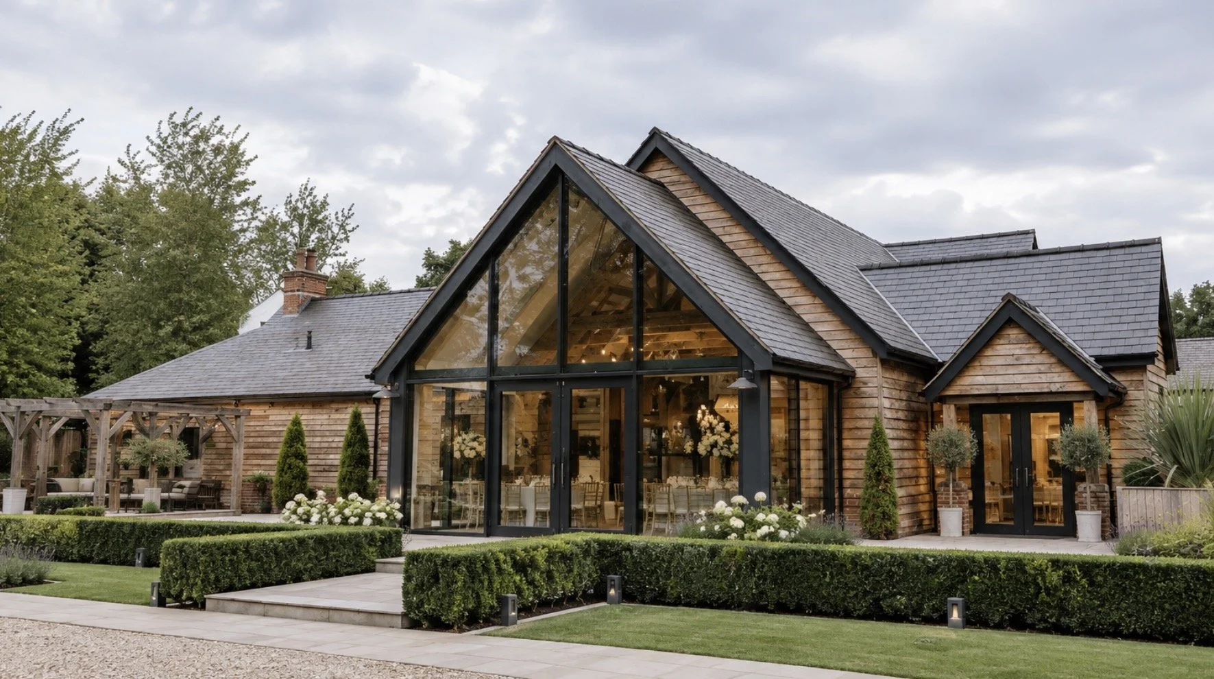 The River Barn, Poulton-le-Fylde, Lancashire — Extension and transformation of Mains Hall into a contemporary wedding venue, featuring a striking glazed entrance, traditional brickwork, landscaped gardens and complete interior redesign.