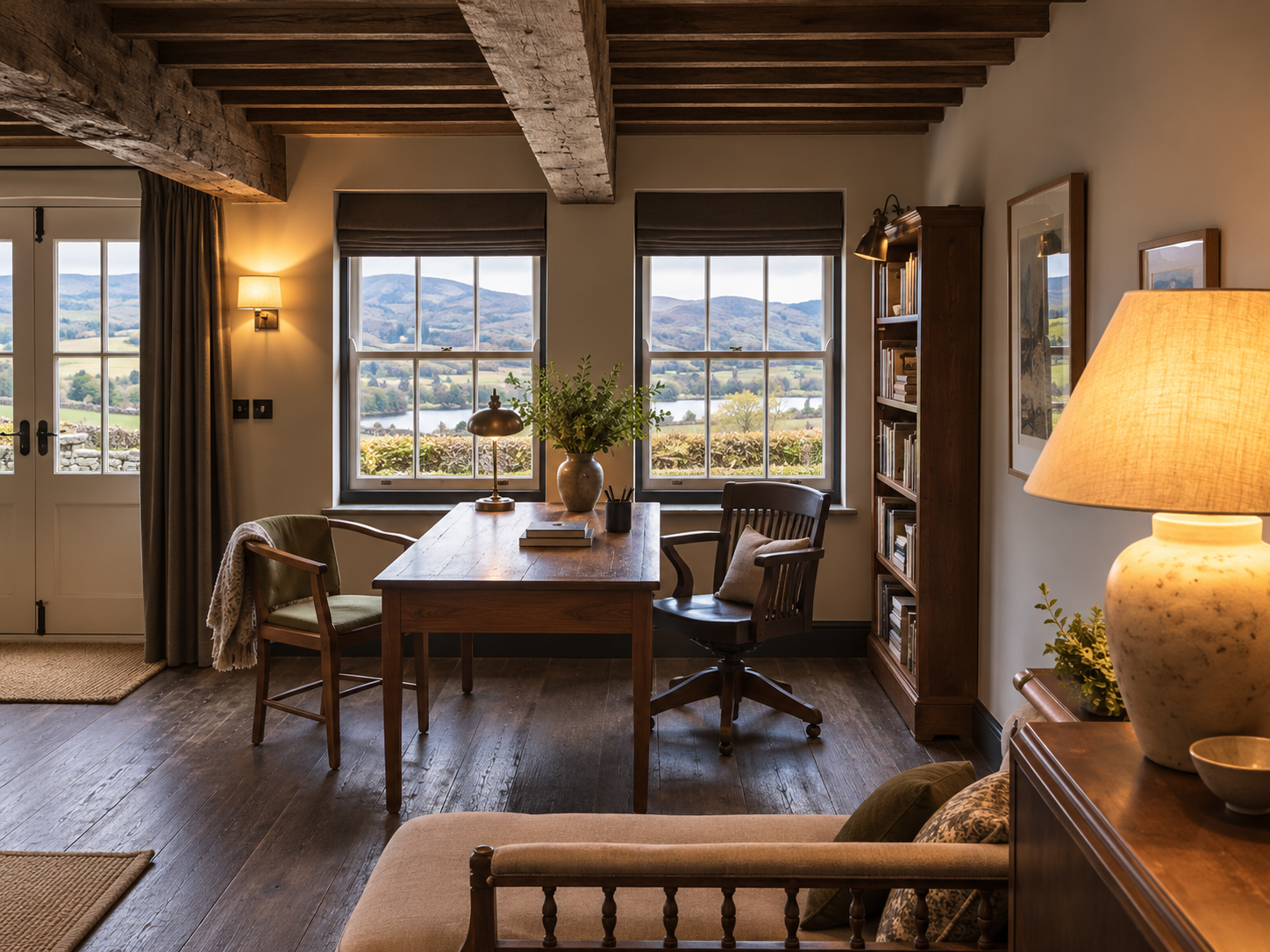 Creative meeting and workspace within the Coniston farmhouse, featuring exposed timber beams, natural materials and inspiring views across the Lakeland countryside.