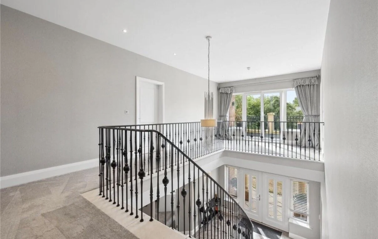 Regent Avenue, Lytham St Annes — First Floor Landing and Staircase — spacious galleried landing overlooking the double-height entrance hall, featuring decorative wrought-iron balustrades, soft neutral finishes and natural light from the upper-floor w