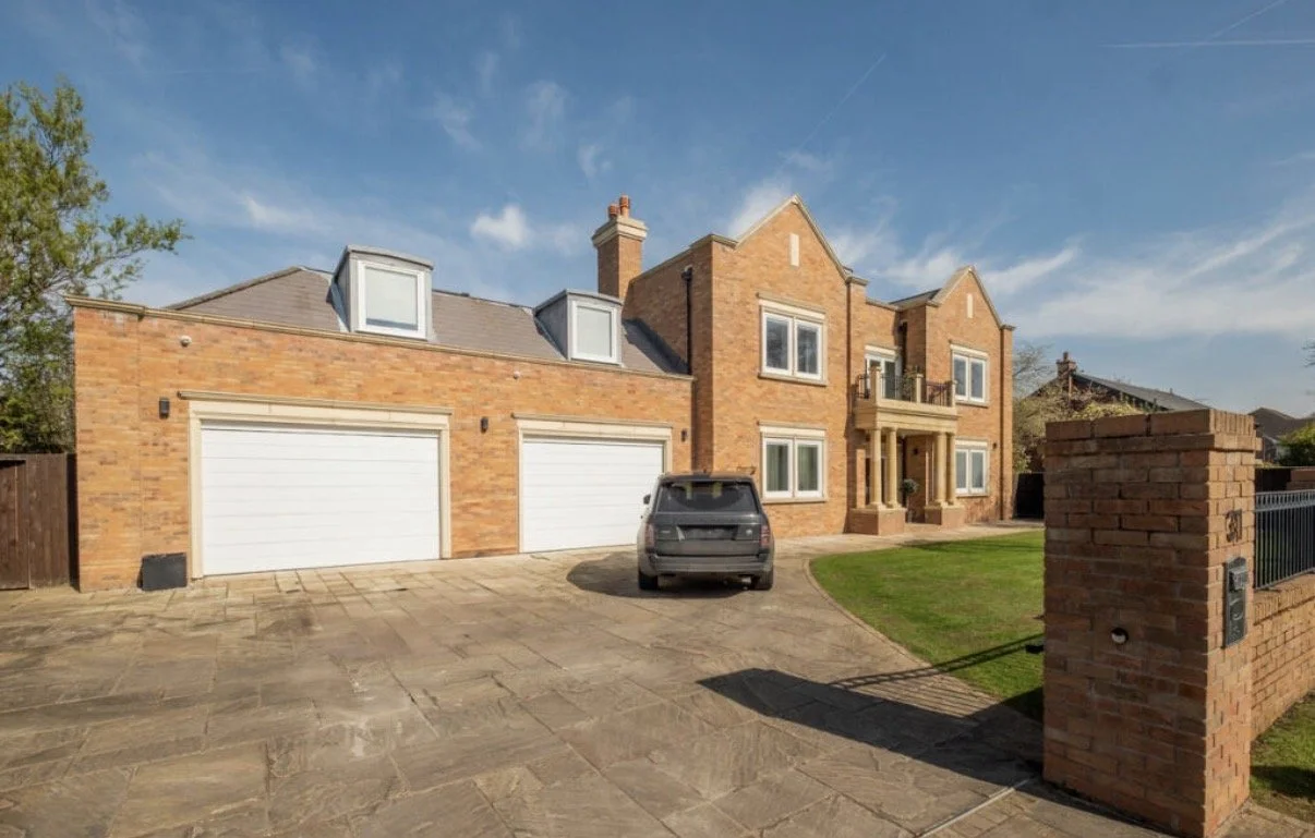 Regent Avenue, Lytham St Annes — New-Build Family Residence — alternative view of this substantial red-brick home, featuring a three-car garage with accommodation above, traditional gabled elevations and a landscaped front garden. The design combines
