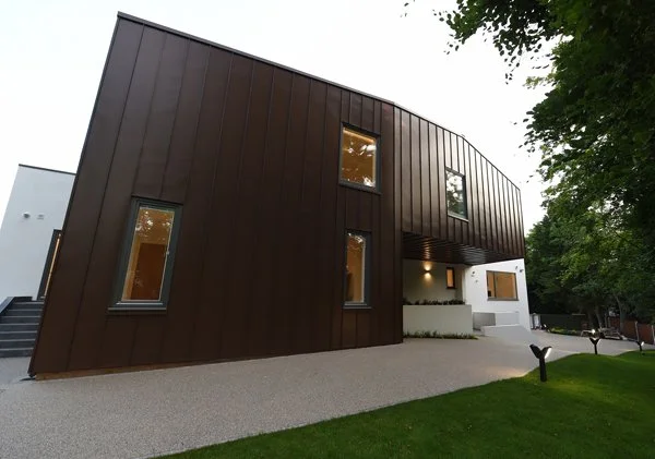 8 Church Drive, Lytham – Sculptural Zinc-Clad Rear Elevation

Architectural photograph showing the dramatic curved zinc-clad façade and cantilevered first floor, creating a distinctive sculptural form overlooking the rear garden and terrace.