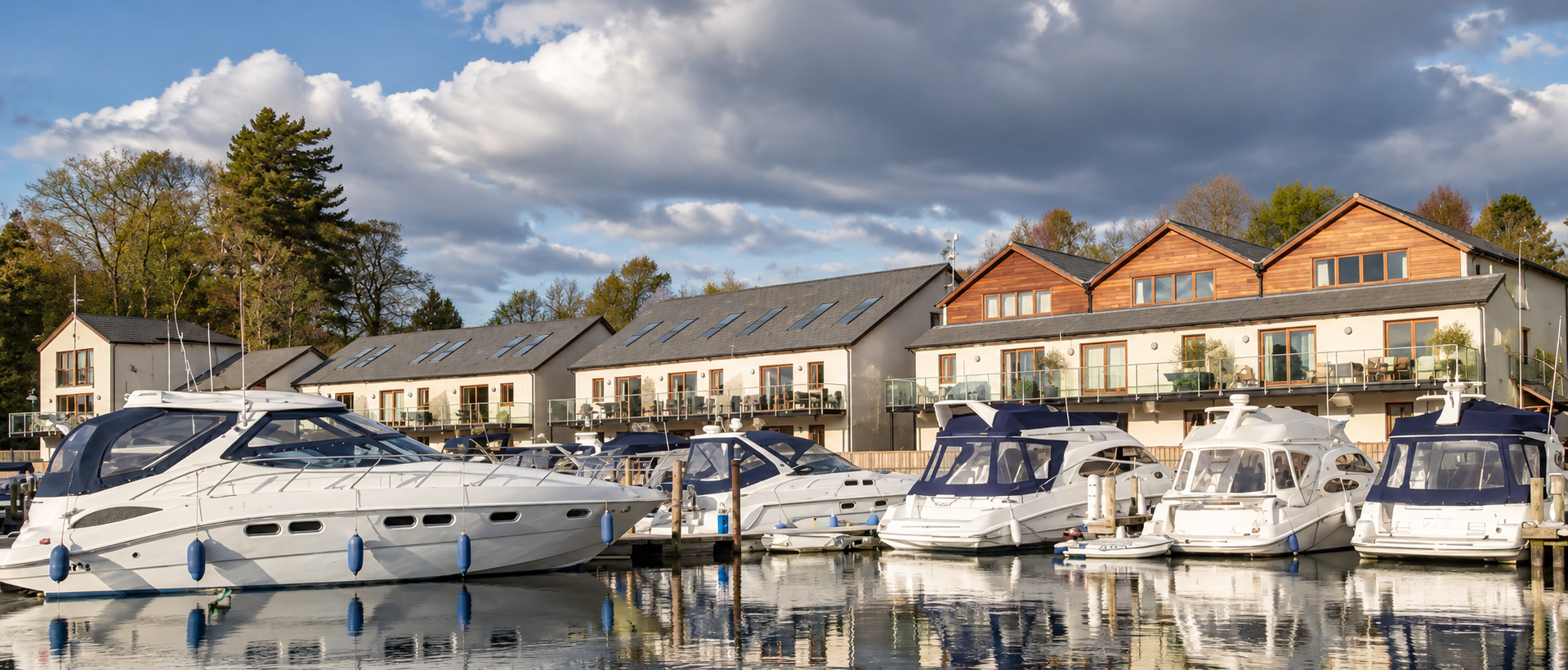 Windermere Marina Village, Phase 1, Lake District, Cumbria — waterfront development of traditional timber-framed houses and apartments designed by Joel Firth, 2003–2005, featuring pitched roofs, private balconies and terraces overlooking the marina a