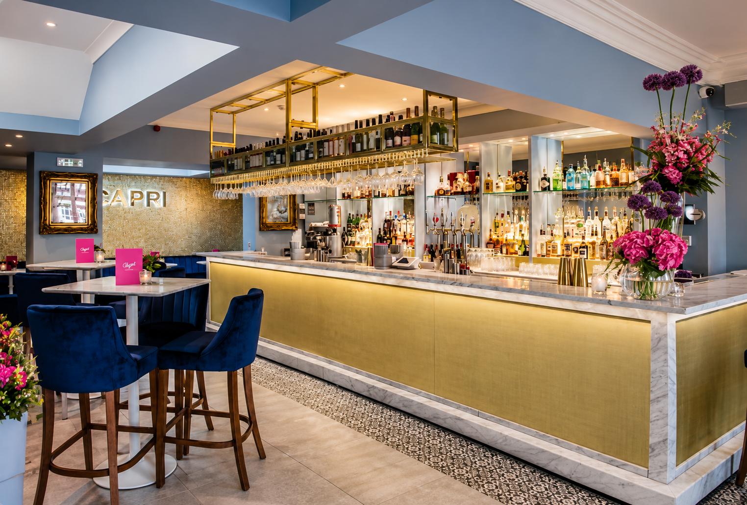 Capri Wine Bar, Lytham St Annes — Completed Interior Design — completed refurbishment and interior design featuring a bespoke brass-finished bar, marble countertops, suspended bottle displays and integrated architectural lighting. Rich blue upholster
