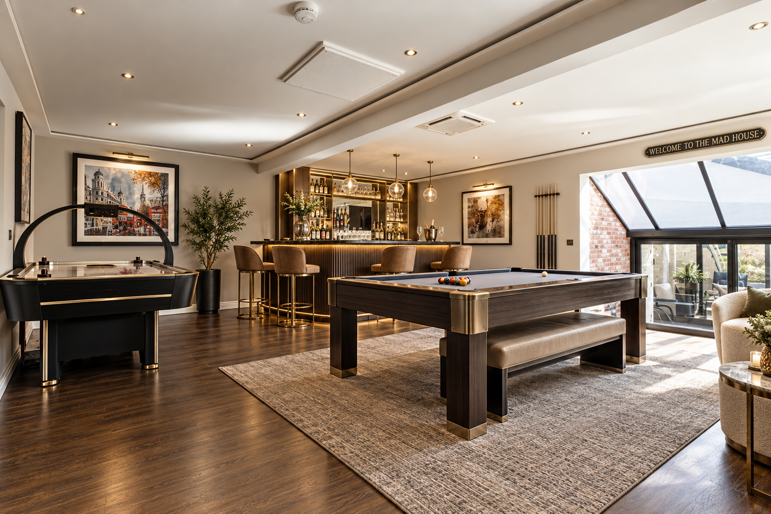 Games Room — Luxury entertainment room featuring a full-size pool table, bespoke bar and integrated architectural lighting.