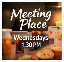 Sign indicating a meeting place on Wednesdays at 1:30 PM, with a background of a conference or meeting room