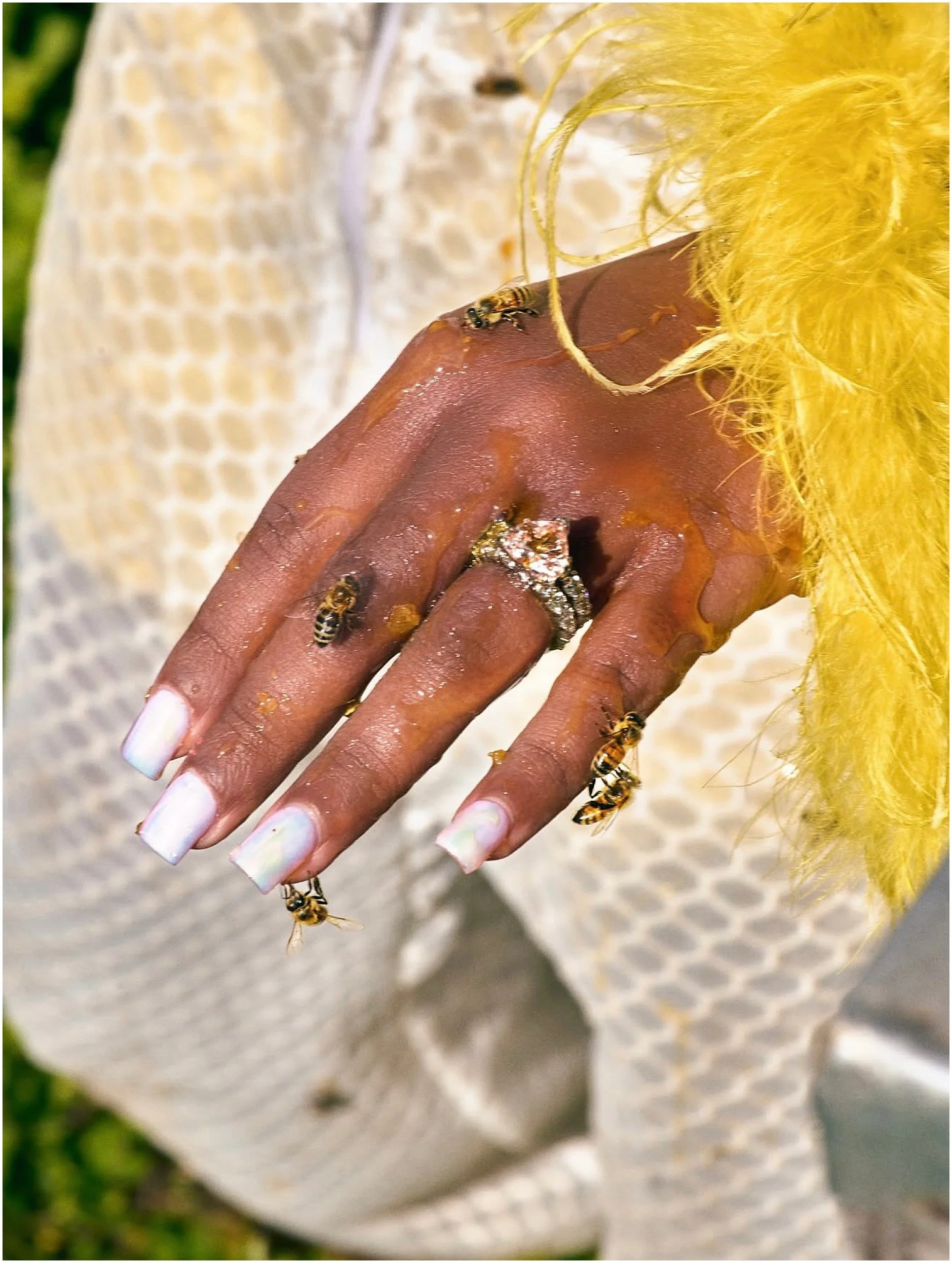 Bride-to-be Erika posing in a Jeometry Sunny Suit women’s beekeeping suit during a stylish apiary engagement session.