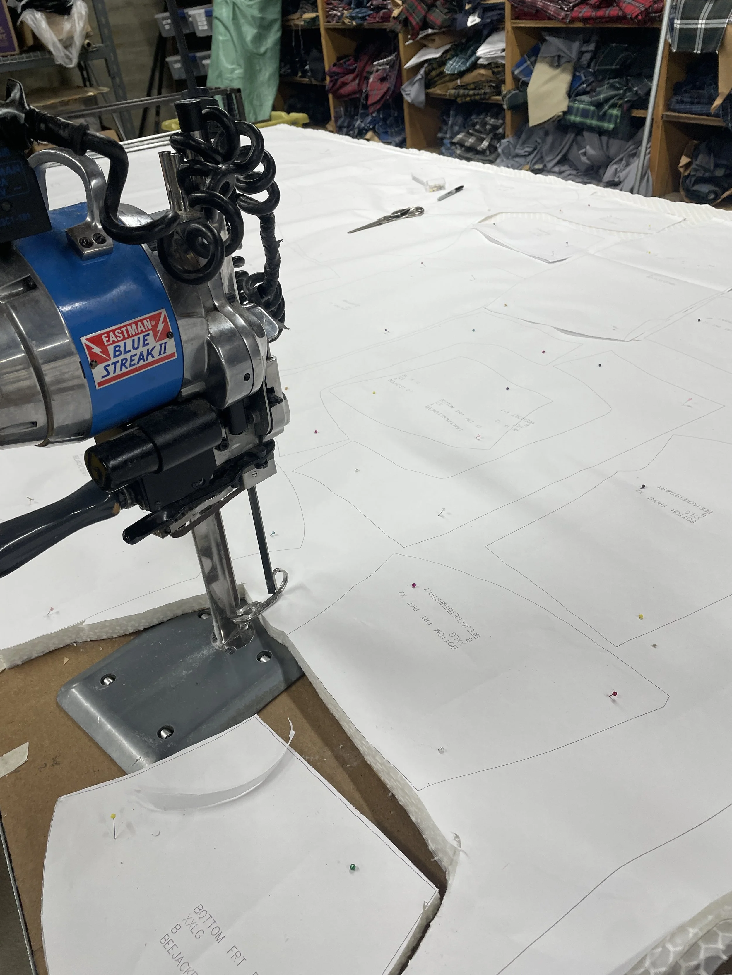 Fabric being cut during production of Jeometry Sunny Suits