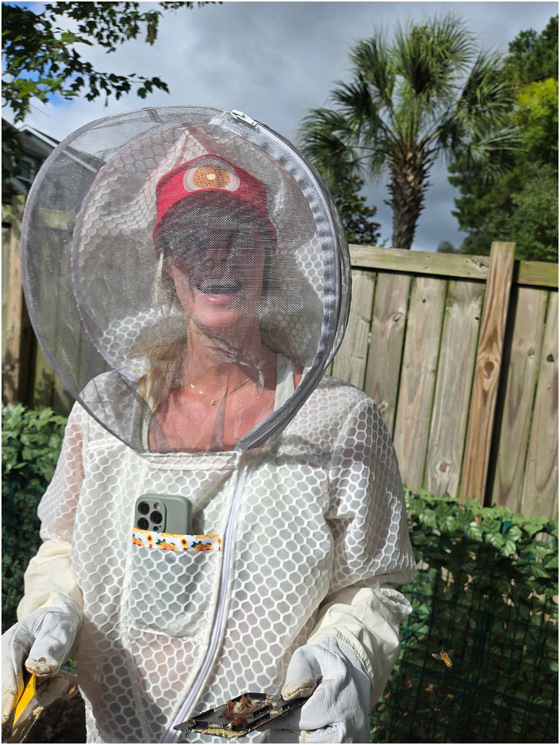 Charleston hobby beekeeper Kailee Habat with her honey bees during a summer hive inspection.