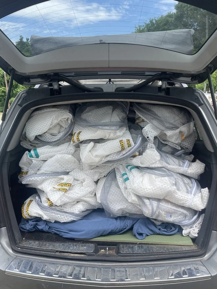 Sunny Suits in the back of a car ready to ship to women beekeepers