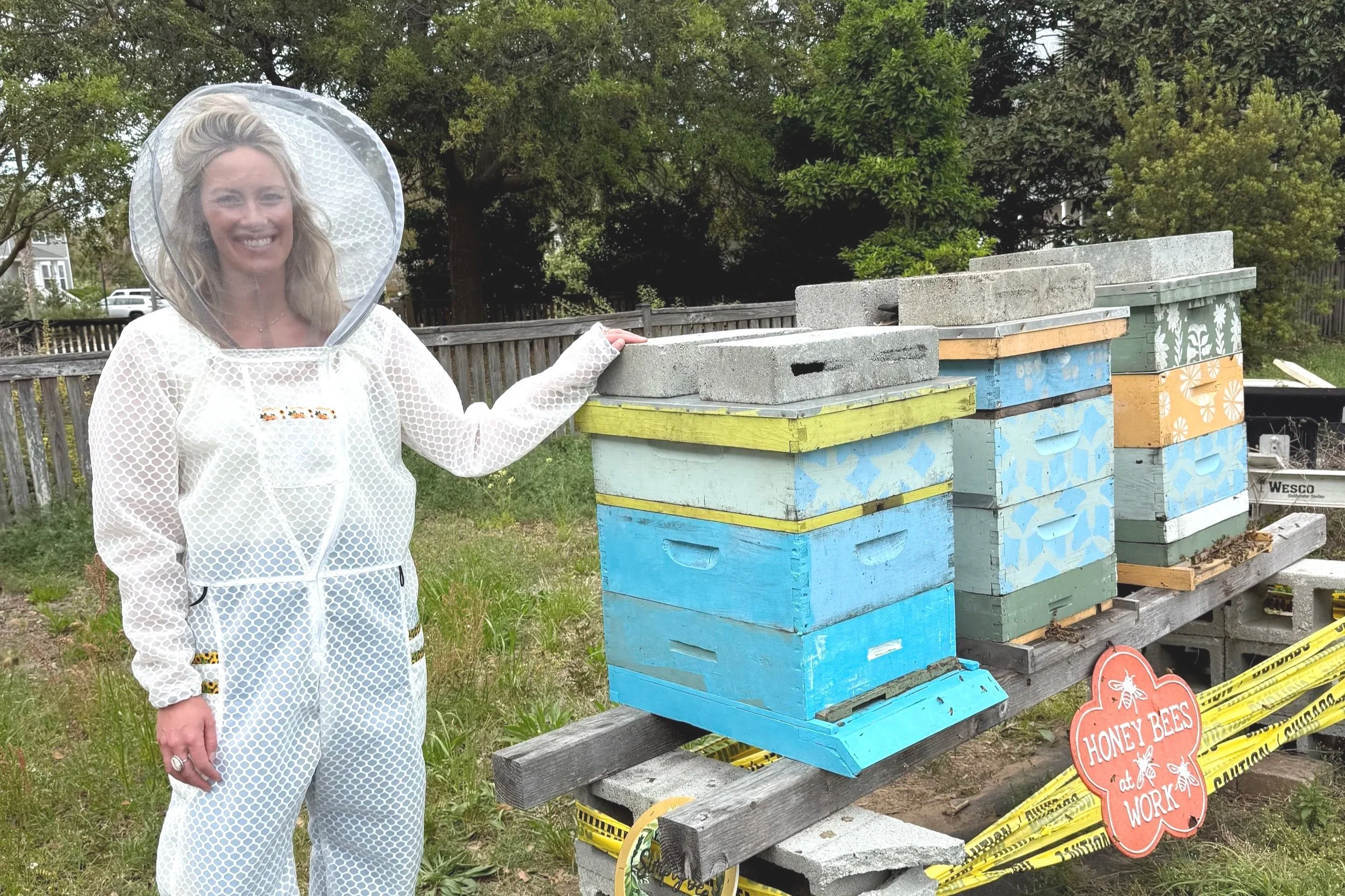 Beginner beekeeper wearing a lightweight and protective beesuit made by Jeometry Beewear™ exclusively for women