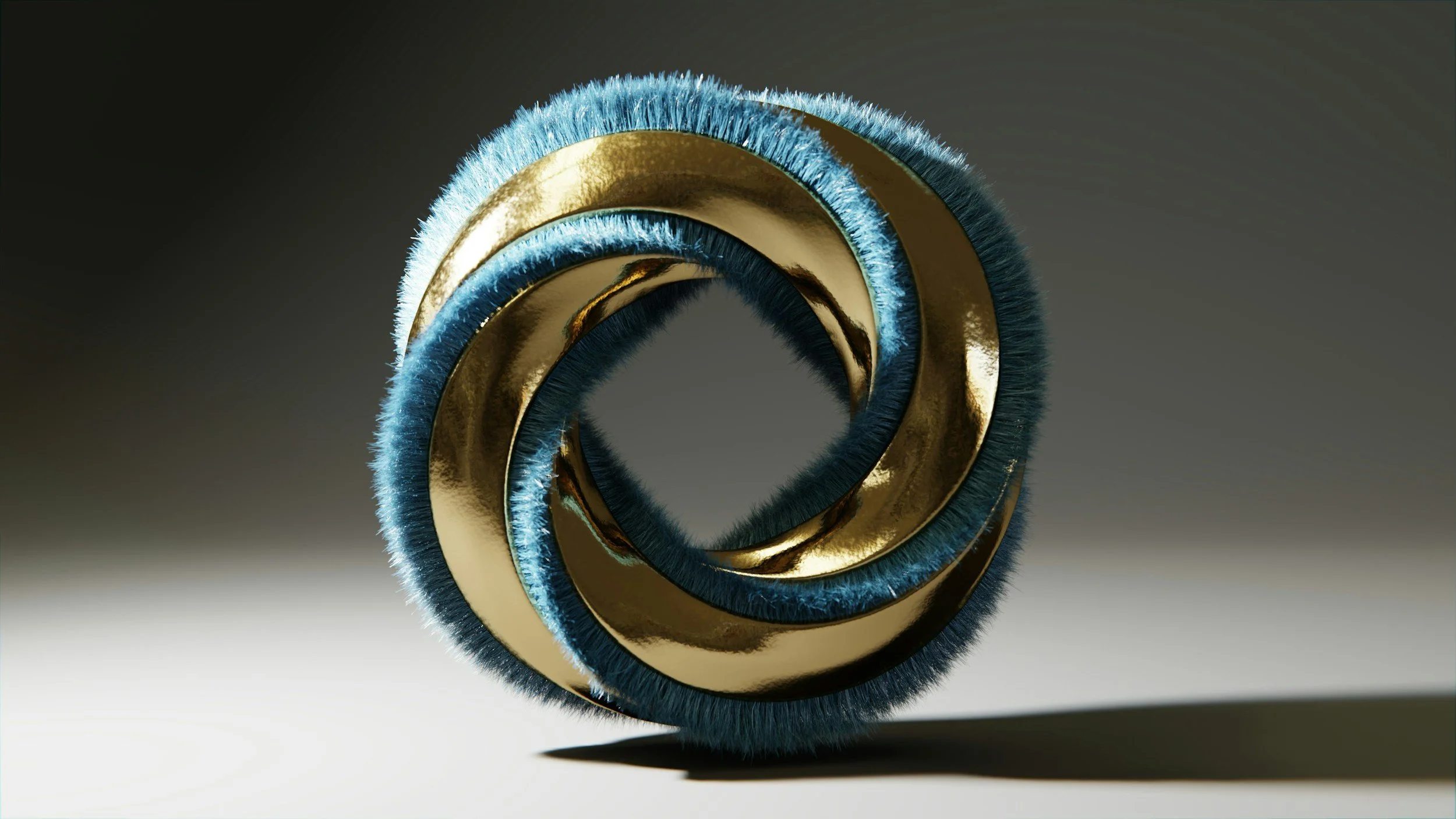 Close-up of a metallic spiral shape with gold and blue accents, with a shadow cast on the surface below.