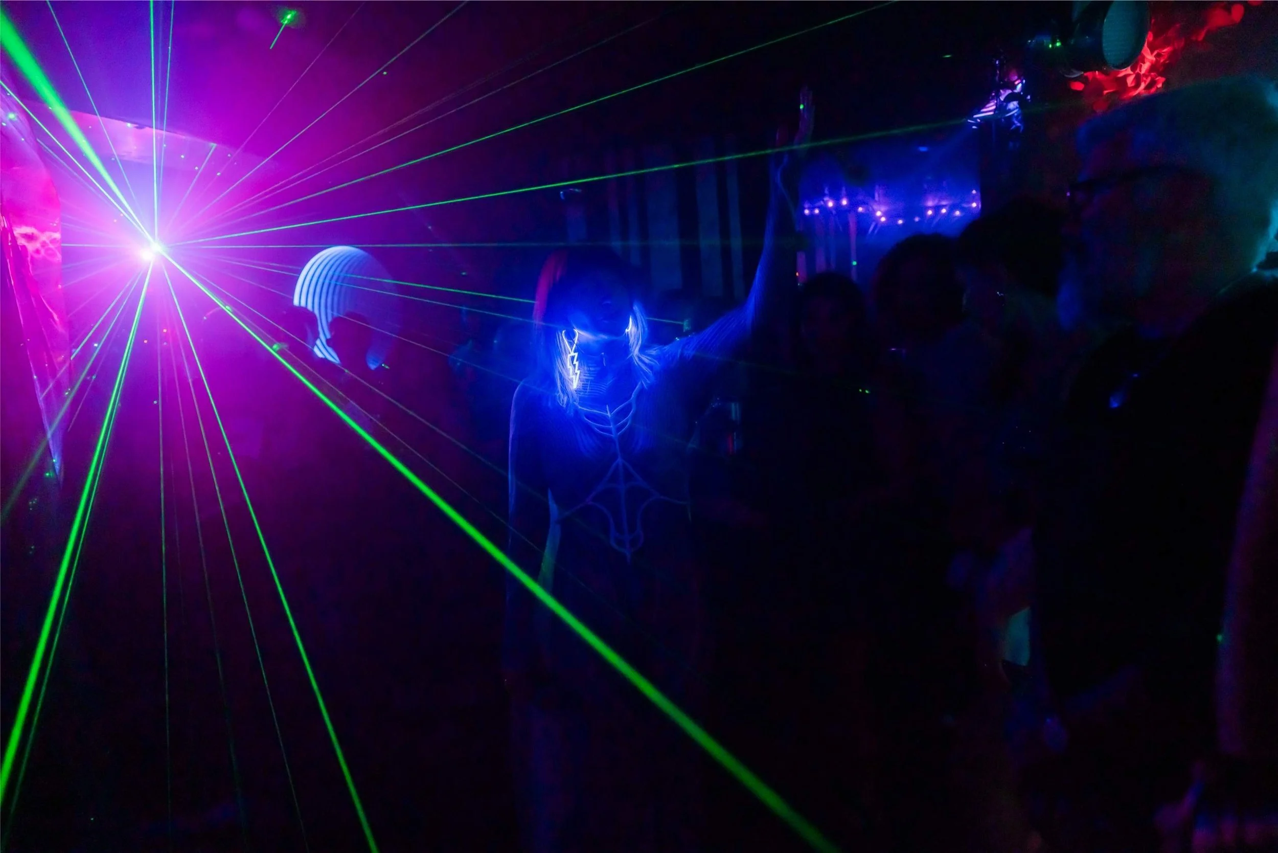 WUNDER BETA performing live at Live Transmission Show in London, with laser lights and colorful illumination.