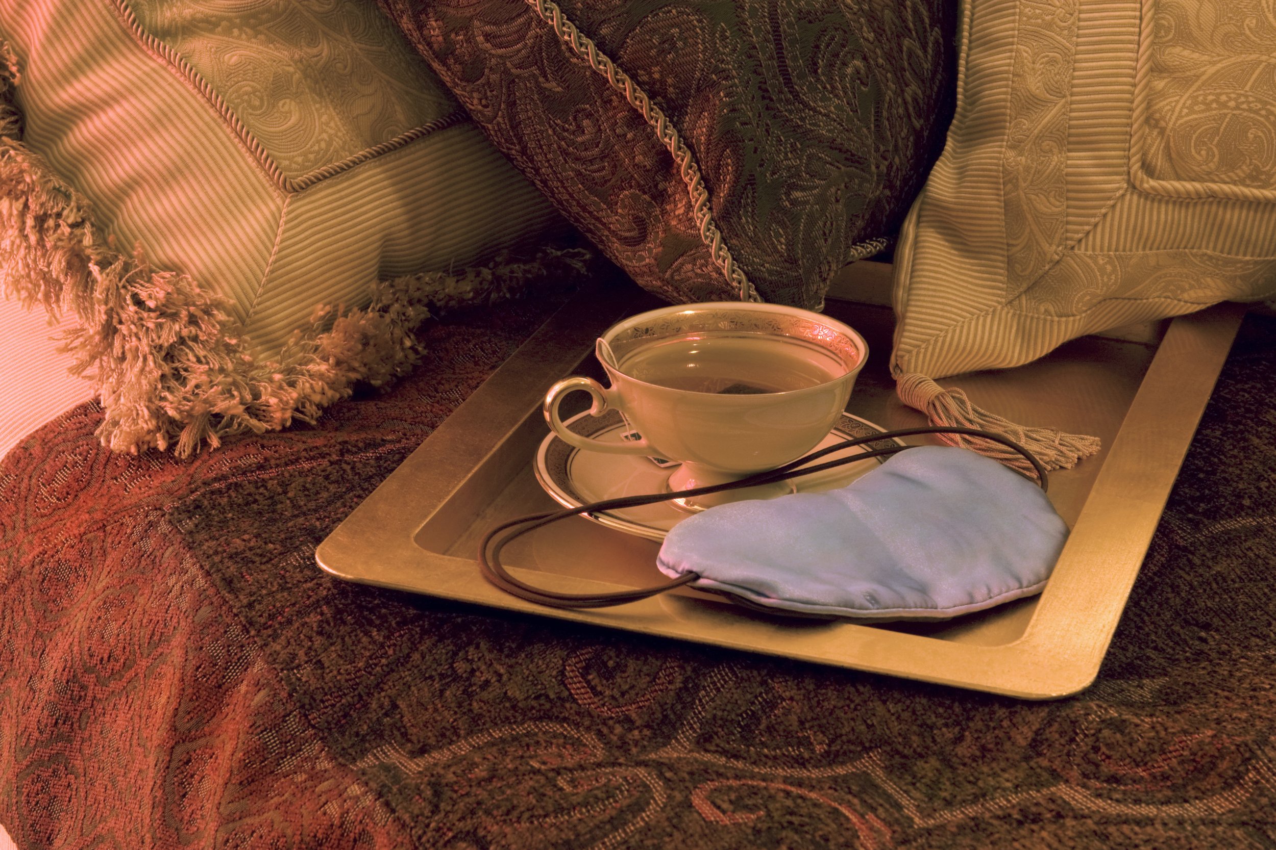 Luxury bedtime tea on a tray with cushions