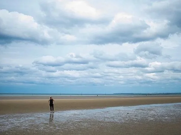 Historian Erin Faith Allen standing alone on Utah Beach, Normandy, France, on the 73rd anniversary of D-Day.