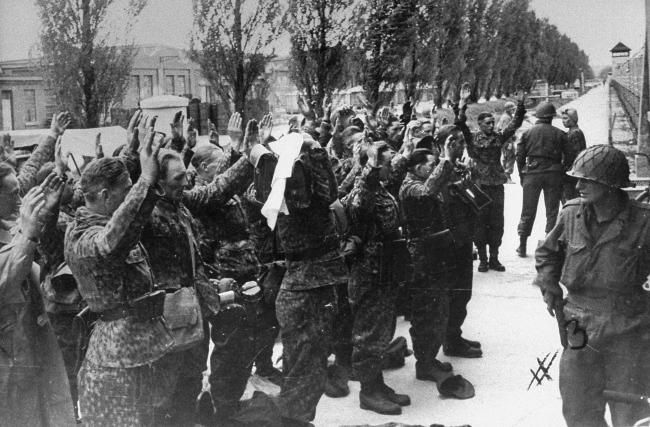 Marguerite Higgins speaking with Lt. Colonel Walter Fellenz, 222nd Infantry Regiment, 42nd Rainbow Division, Dachau concentration camp, April 29 1945
