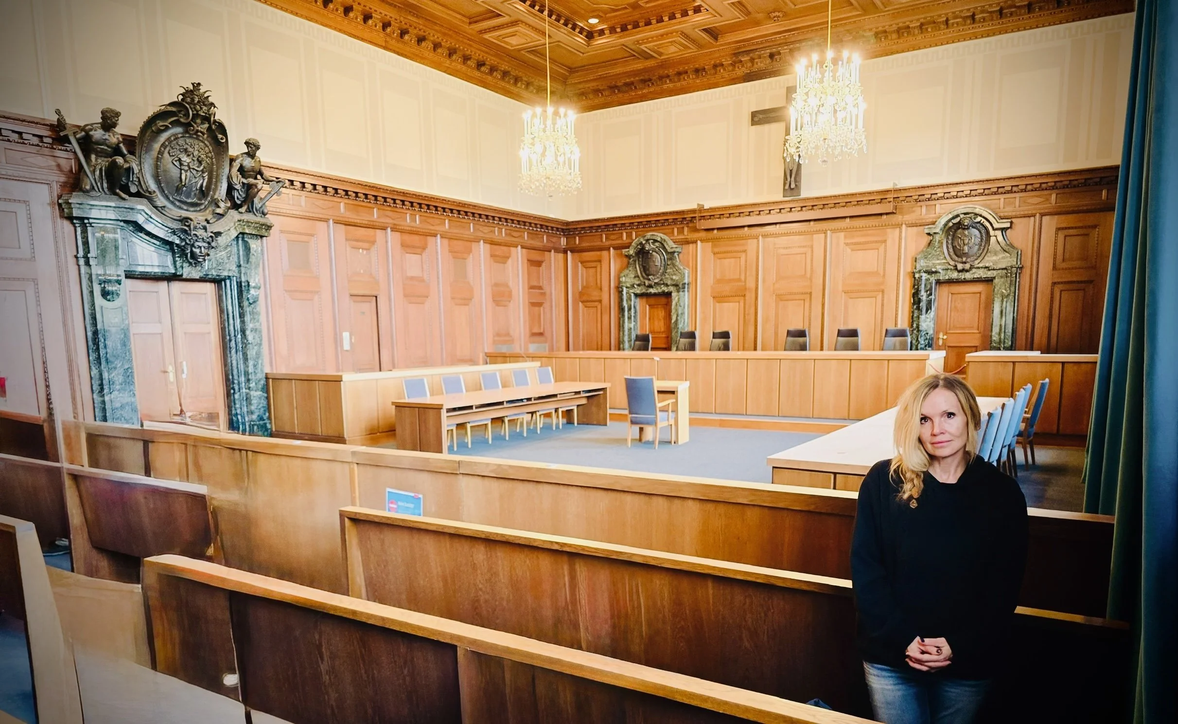Historian Erin Faith Allen standing inside Courtroom 600 at the Palace of Justice, Nuremberg where the WWII war crimes trials took place